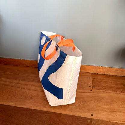 Stor bag med blå tall fra seil, oransje stropper