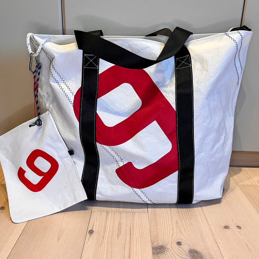 Bestillingsvare!
Stor bag med glidelås og clutch,svarte remmer og rødt 9-tall